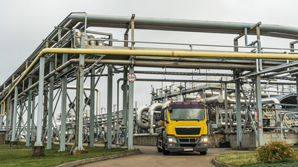 Yellow tanker truck at oil terminal. Petrochemical concept.