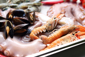 Fresh seafood, mussels, octopus, shrimp, crayfish. A composition of seafood, vegetables and herbs. food background.