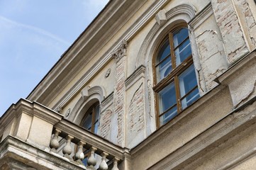 old rustic building with windows and balcony
