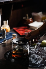 bartender makes original tea with cinnamon and apples