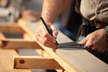 Fototapeta na wymiar man working on a wooden board