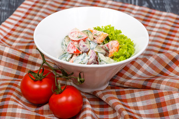 appetizer of tomatoes, cucumbers, peppers, lettuce and sour cream