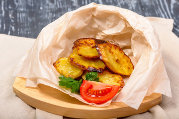 snack of fried potatoes in the village with tomatoes and herbs