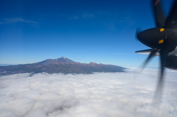 Naklejka na ściany i meble Aerial overcloud view on Tenerife island from airplane
