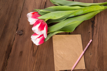 Pink tulips on dark background. Flat lay, top view. Copy space.
