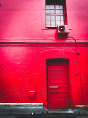 red building with red door, window and air condition