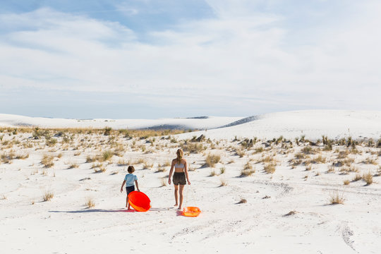 children pulling sleds, White Sands Nat'l Monument, NM,White Sands National Monument