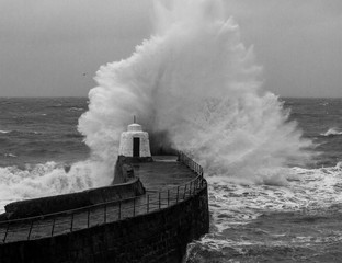 big wave hits harbour wall Portreath Cornwall
