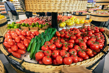 Vegetable basket with different types of tomatoes and cucumbers