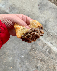 One Hand Holding a Large Piece of Bread with Huge Amount of Blood Sausage Very Tasty Made as...