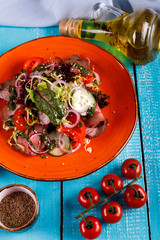 salad with sliced roast beef, tomatoes , cucumber in a plate