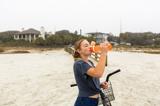 Teenage girl drinking water, St. Simon's Island Georgia,St Simon's Island