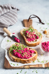 Bruschetta with Beetroot hummus decorated with chopped nuts and microgreen. Vegan recipes,...