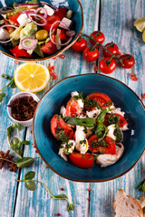 Freshly prepared Caprese salad with mozzarella, cherry tomatoes, Basil and arugula pesto.