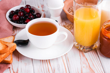 Delicious and healthy breakfast on a light wood table.