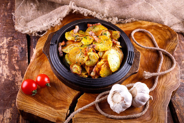 Fried potatoes with meat on a baking sheet