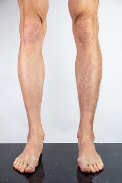 Crop man with shaved and hairy legs
