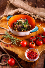 grilled cauliflower with cheese in a plate on a wooden background