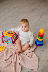 baby is sitting on the floor playing with educational toys