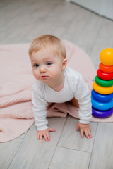 baby is sitting on the floor playing with educational toys