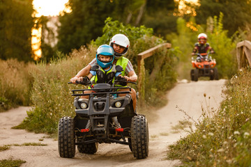little boy with instructor on a quad bike © Angelov