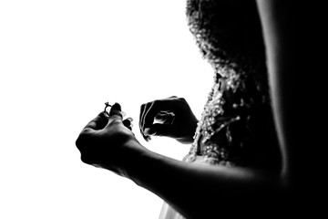 The bride holds the ring in her hand
