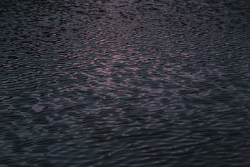 Reflection in the water of the sky with the sun under