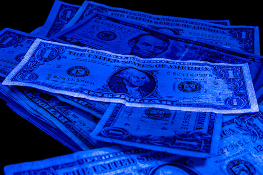 1. 5 dollars - United States paper currency under UV light. Verifying the authenticity.Suspicious, fake falsificate 1 $