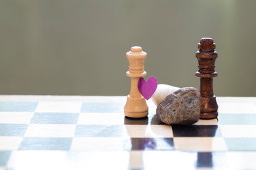 Love and racial prejudice. Chess pieces on a chessboard.