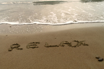 Word Relax on beach sand