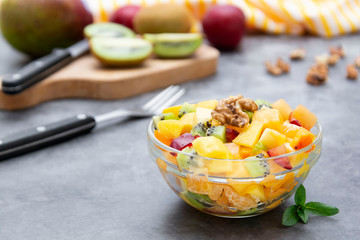 Healthy fruits salad - mango, citrus, kiwi fruit, plum and persimmon. clean eating.