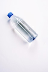 plastic bottle with a sparkle of water on a white background. Copyspace, place for text