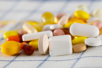 A large dose of pills is on the napkin