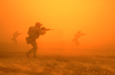 Military troops on the way to the battlefield in desert.
