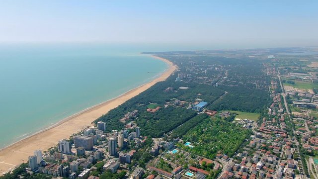 AERIAL: Cityscape landscape view of the lignano coastline. travel vibes. sunny day. Italy