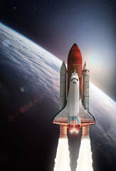 Space shuttle rocket in oe Earth planet. Deep space and sun on background. Exploration and science. Elements of this image furuter space on orbit of thnished by NASA	