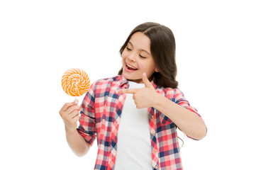 Look at this. Little girl point at candy isolated on white. Small child smile with hard candy on stick. Candy shop. Candy made for me. Lollipop makes her happy