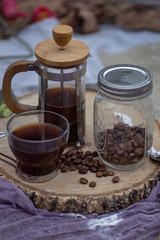 Coffee cup with brewing accessories on wooden board