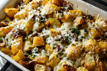 Baked potatoes with mushrooms and cheese with seasonings and herbs