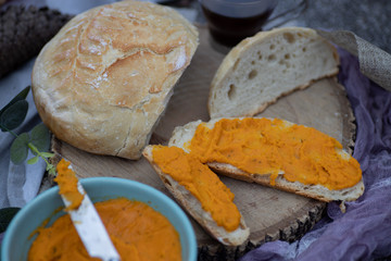 Artisan bread sliced and spread with vegan carrot pate
