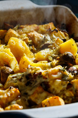 Baked potatoes with mushrooms and cheese with seasonings and herbs
