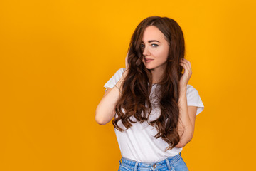 beautiful brunette girl on a yellow background