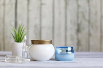 Cosmetic creams on the background of wooden boards