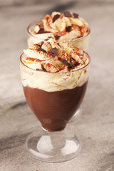 Hot chocolate cocoa in glas cup with whipped cream on vintage background