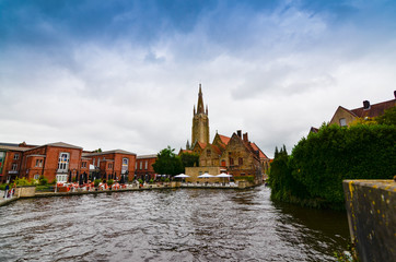 Obraz premium Bruges, flanders belgium. August 2019. The bridges over the canals are a symbol of the city: with pretty planters characterize the place.