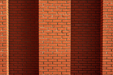 Red brick wall in sunlight.