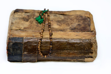 The old, worn and patched Qur'anic religious book.