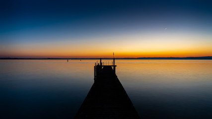 Pier after sunset with lake background