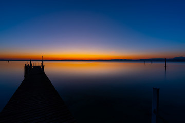 pier after sunset with lake background