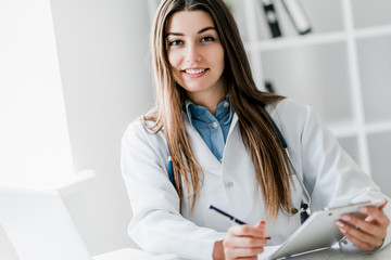 Portrait of happy successful female doctor